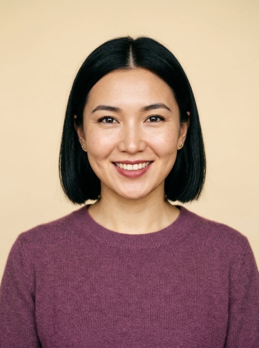 Professional studio headshot of a 26-year-old Central Asian woman with a blunt bob in jet black with