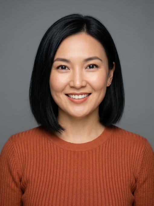 Professional studio headshot of a 30-year-old Central Asian woman with a chin-length bob in jet blac