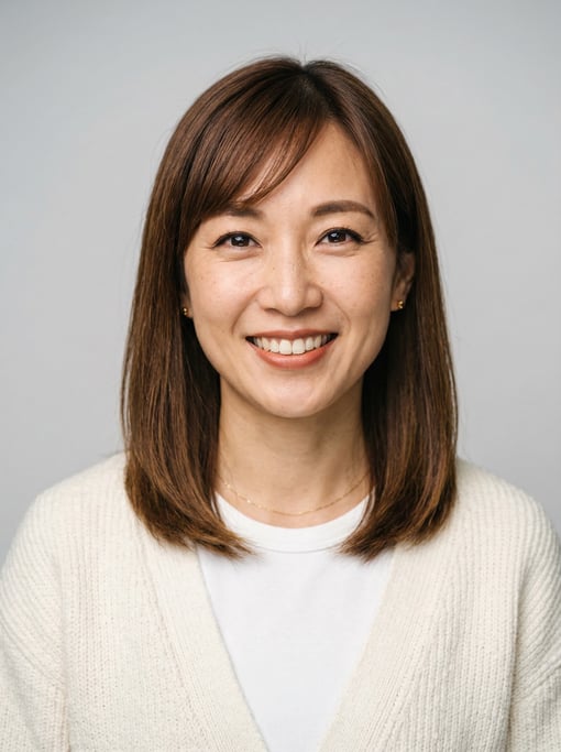 Professional studio headshot of a 36-year-old East Asian woman with shoulder-length straight brown h