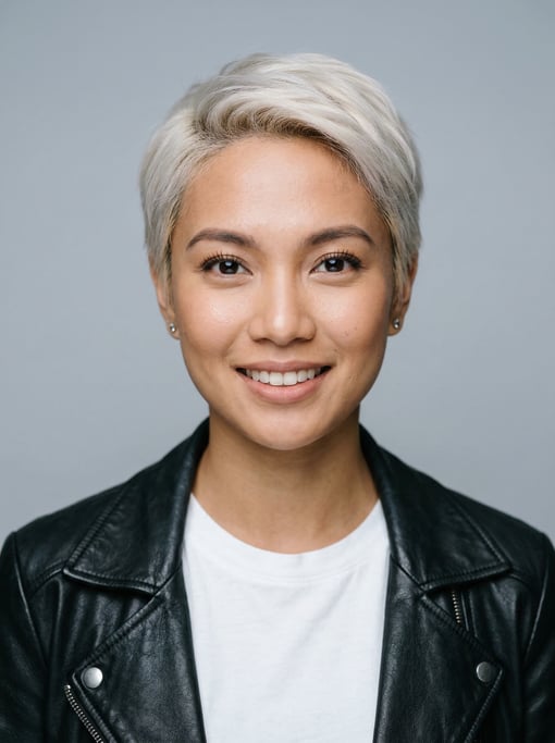 Professional studio headshot of a 25-year-old Southeast Asian woman with a short pixie cut in platin