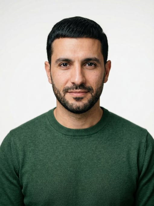 Professional studio headshot of a 34-year-old Lebanese man with a Caesar cut in black