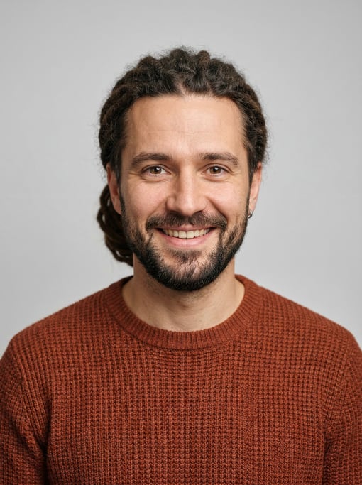 Professional studio headshot of a 35-year-old White Eastern European man with medium dreadlocks pull