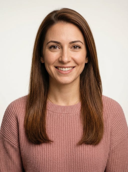 Professional studio headshot of a 27-year-old White Mediterranean woman with long straight chestnut