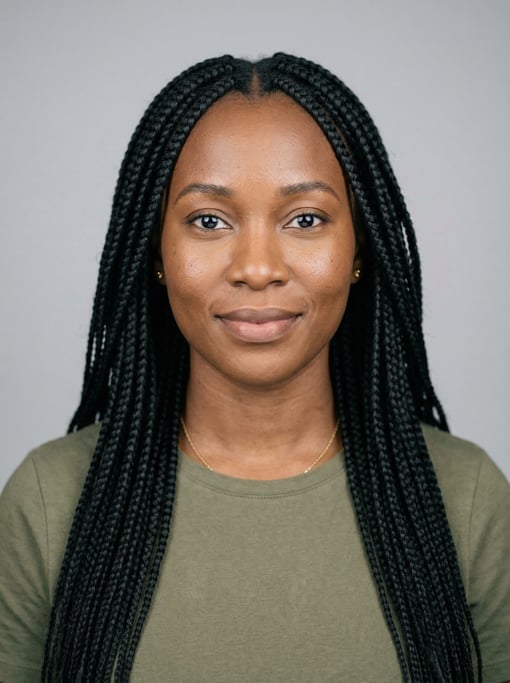 Professional studio headshot of a 34-year-old Ghanaian woman with long box braids in black