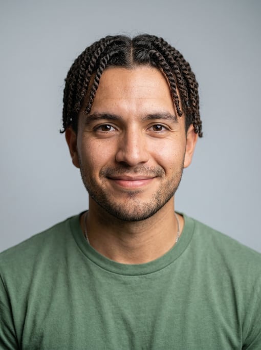 Professional studio headshot of a 24-year-old Mexican man with twists in dark brown
