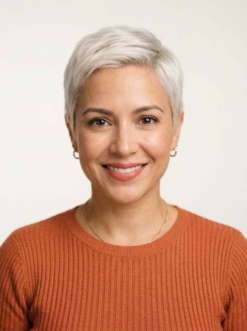 Professional studio headshot of a 34-year-old Latina woman with a short pixie cut in platinum blonde
