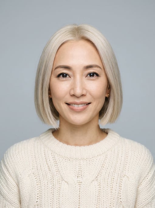 Professional studio headshot of a 38-year-old Japanese woman with a blunt bob in platinum blonde