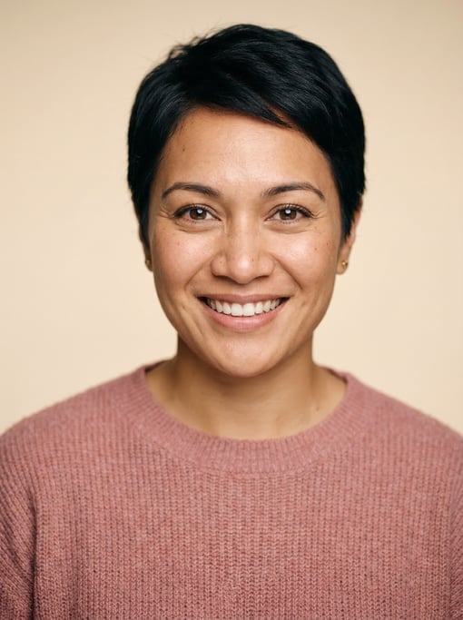 Professional studio headshot of a 29-year-old Pacific Islander woman with a short pixie cut in black