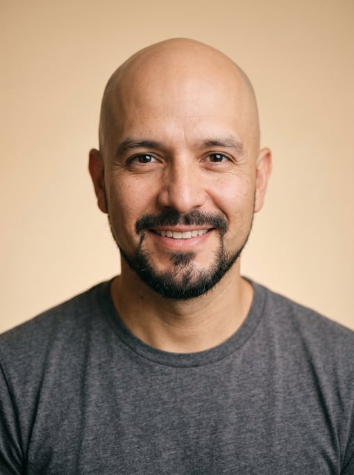 Professional studio headshot of a 38-year-old Colombian man with a completely bald head, a goatee