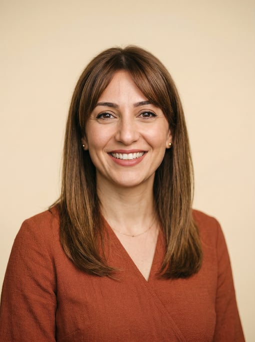 Professional studio headshot of a 37-year-old Middle Eastern woman with shoulder-length straight bro