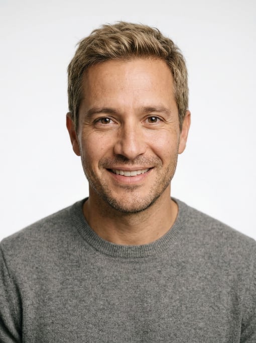 Professional studio headshot of a 40-year-old Latino man with short dirty blonde hair