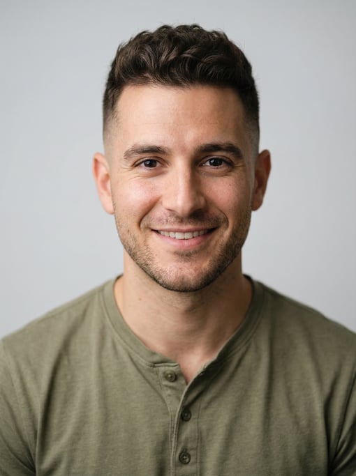 Professional studio headshot of a 28-year-old White Mediterranean man with a mid fade with textured