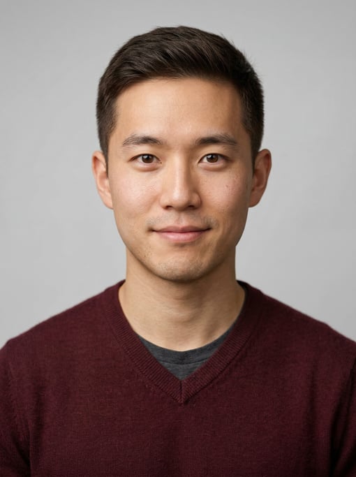 Professional studio headshot of a 24-year-old East Asian man with short cropped dark brown hair