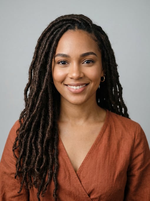 Professional studio headshot of a 25-year-old Dominican woman with long goddess locs in dark brown
