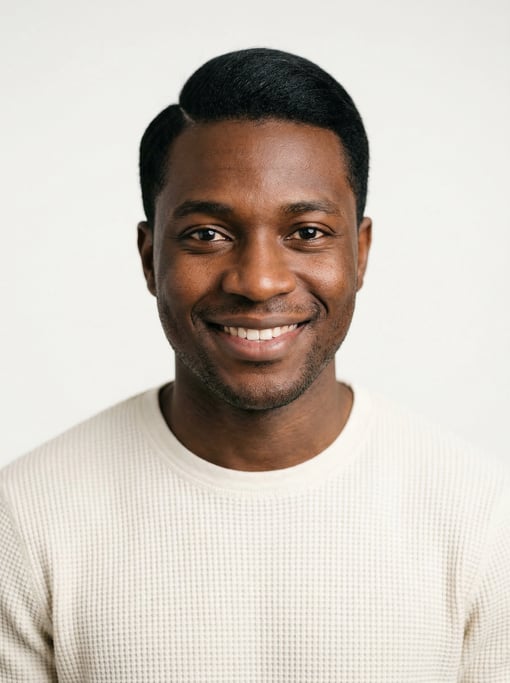 Professional studio headshot of a 26-year-old Nigerian man with neat black side-parted hair