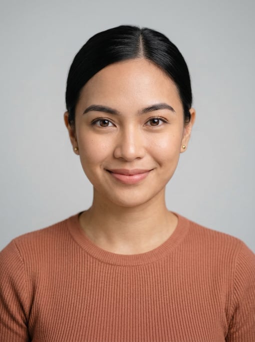 Professional studio headshot of a 24-year-old Filipino woman with a sleek low bun in black