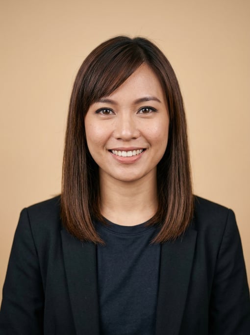 Professional studio headshot of a 31-year-old Southeast Asian woman with shoulder-length straight br