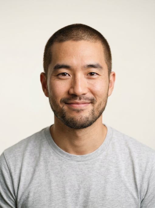 Professional studio headshot of a 31-year-old Korean man with a buzz cut in brown