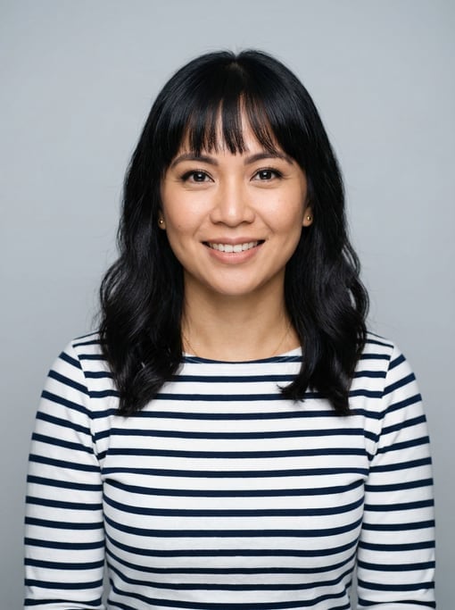 Professional studio headshot of a 34-year-old Filipino woman with blunt bangs with shoulder-length b