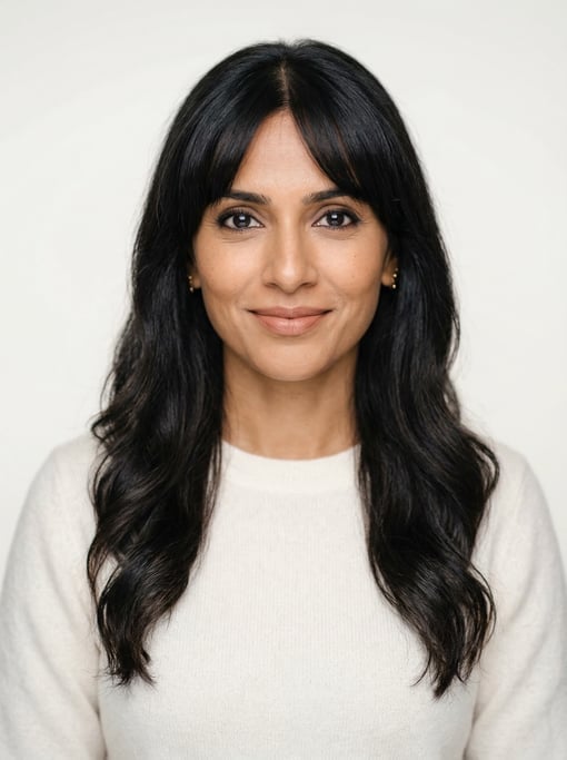 Professional studio headshot of a 39-year-old Indian woman with curtain bangs with long dark hair
