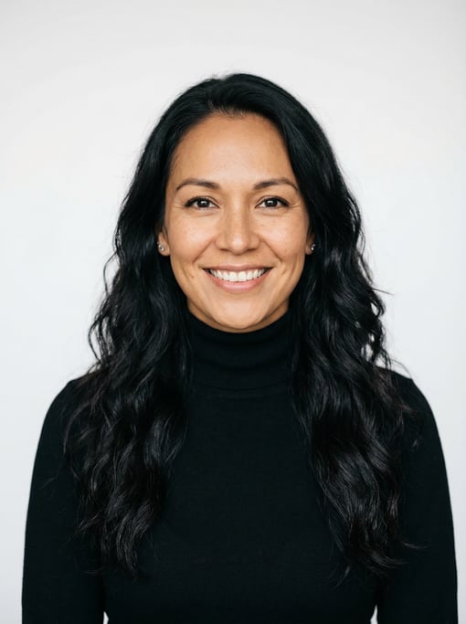 Professional studio headshot of a 33-year-old Native American woman with long wavy black hair