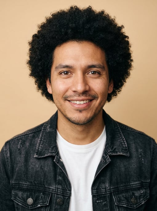 Professional studio headshot of a 26-year-old Mexican man with a medium natural afro in black