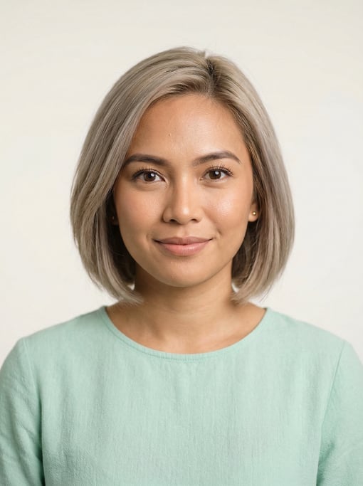 Professional studio headshot of a 28-year-old Filipino woman with a chin-length bob in ash blonde