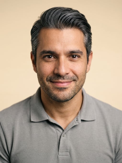 Professional studio headshot of a 33-year-old Brazilian man with silver-streaked dark hair combed ba