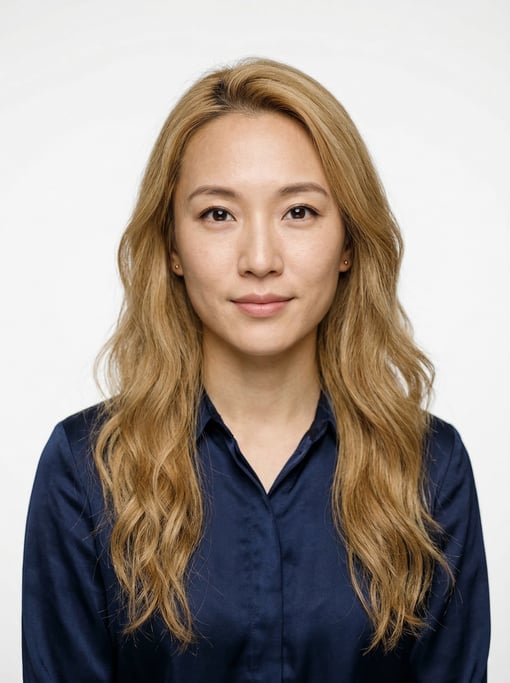 Professional studio headshot of a 27-year-old Chinese woman with long wavy honey blonde hair