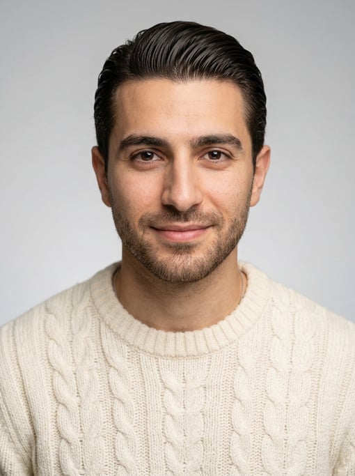 Professional studio headshot of a 27-year-old Lebanese man with a slicked-back style in dark brown