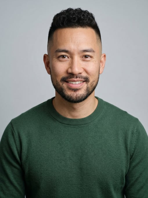 Professional studio headshot of a 37-year-old East Asian man with a high fade with short curly top