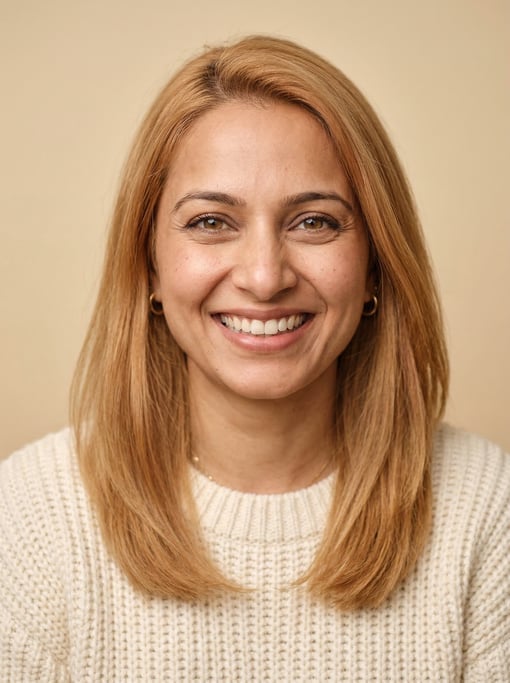 Professional studio headshot of a 34-year-old Indian woman with fine straight strawberry blonde hair