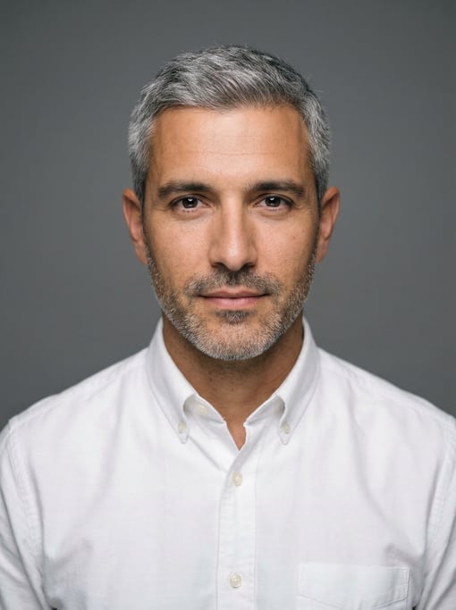 Professional studio headshot of a 32-year-old White Mediterranean man with fully grey short cropped