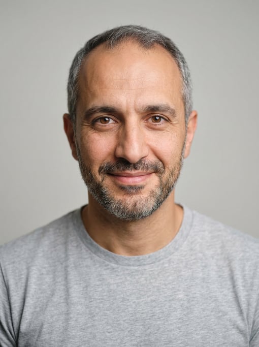 Professional studio headshot of a 38-year-old Middle Eastern man with receding hairline with short g