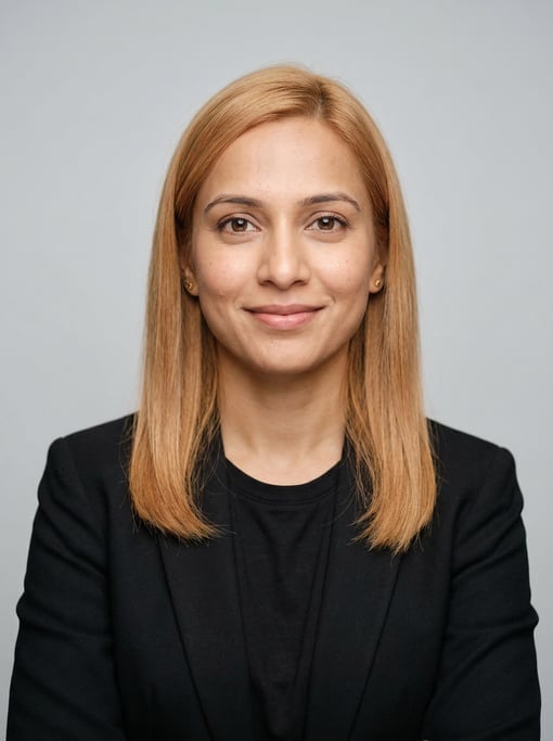 Professional studio headshot of a 33-year-old Indian woman with fine straight strawberry blonde hair