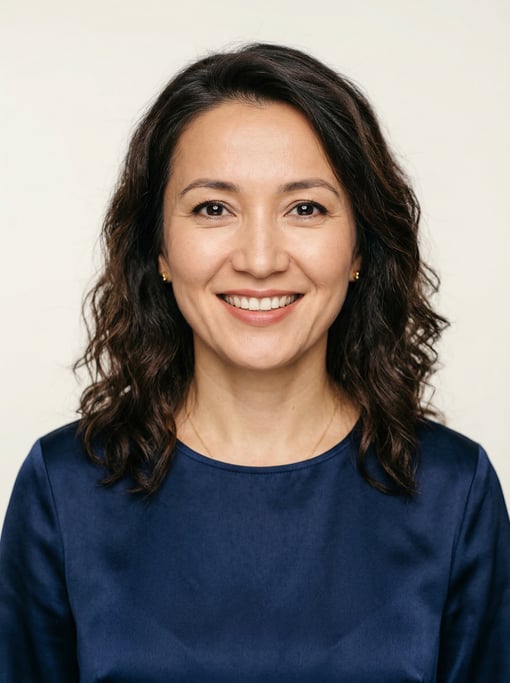Professional studio headshot of a 39-year-old Central Asian woman with shoulder-length wavy dark hai