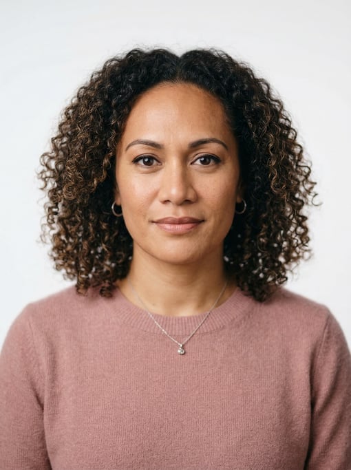 Professional studio headshot of a 40-year-old Pacific Islander woman with shoulder-length coily natu