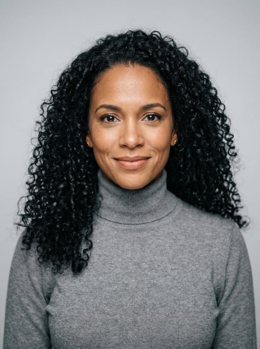 Professional studio headshot of a 39-year-old Puerto Rican woman with long tight curls in black