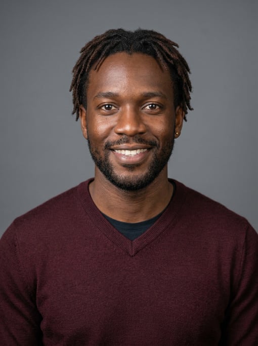 Professional studio headshot of a 32-year-old West African man with short locs in dark brown