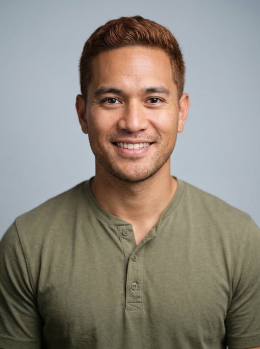 Professional studio headshot of a 30-year-old Hawaiian man with short auburn hair
