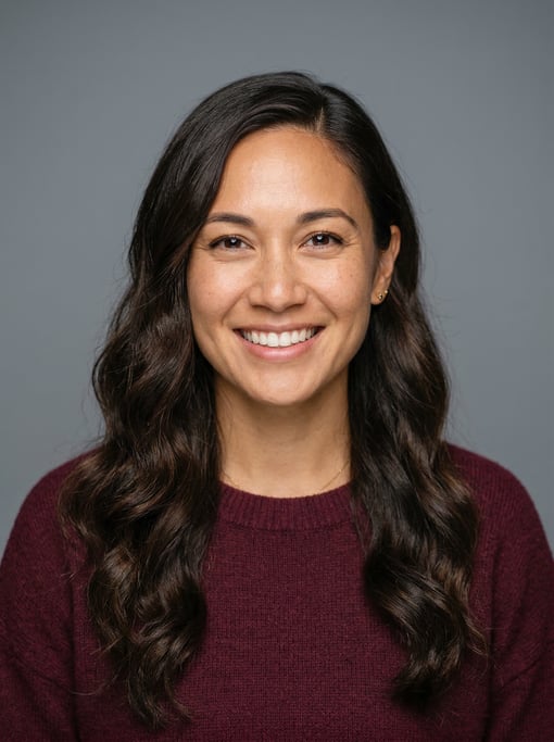 Professional studio headshot of a 31-year-old Hawaiian woman with a deep side part with long brown w