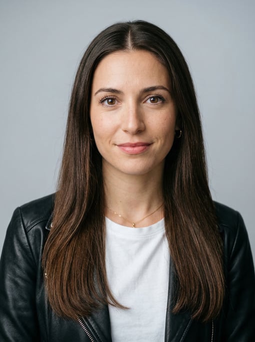 Professional studio headshot of a 26-year-old White Mediterranean woman with long straight dark brow