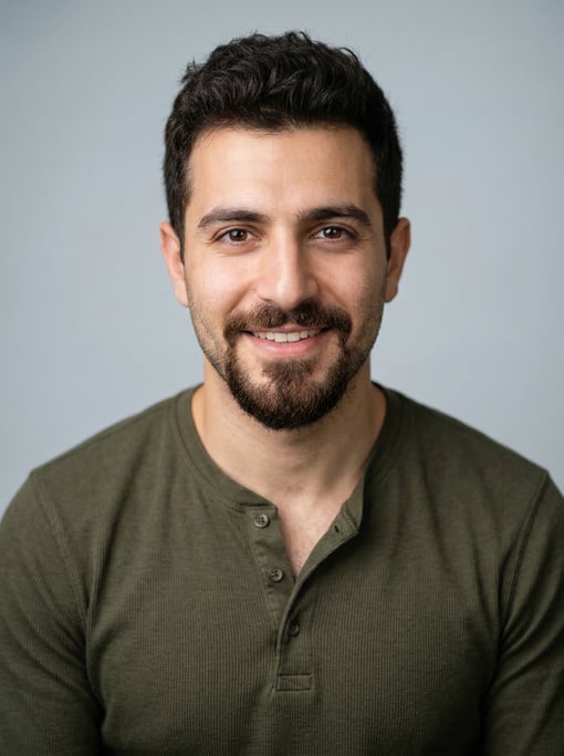 Professional studio headshot of a 28-year-old Lebanese man with short textured dark brown hair