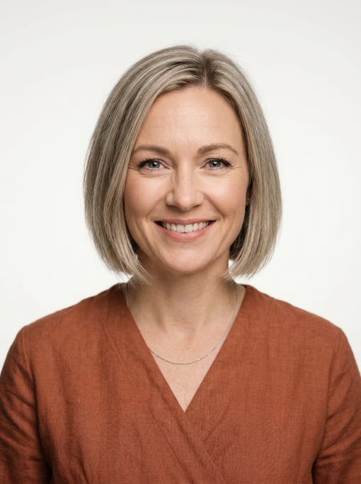 Professional studio headshot of a 40-year-old White European woman with a chin-length bob in ash blo