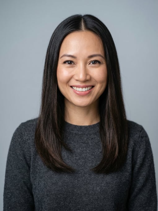Professional studio headshot of a 34-year-old Vietnamese woman with long straight dark brown hair wi