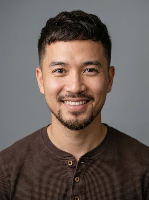 Professional studio headshot of a 31-year-old Vietnamese man with a French crop in dark brown