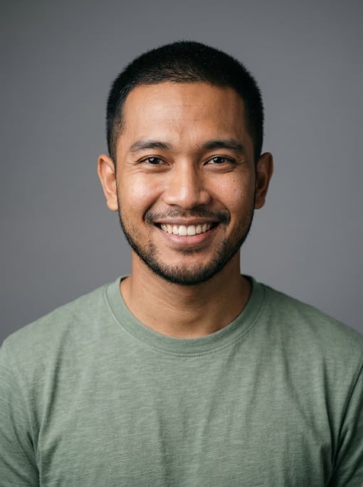 Professional studio headshot of a 25-year-old Indonesian man with short cropped black hair