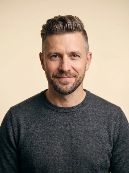 Professional studio headshot of a 40-year-old White Eastern European man with an undercut with longe