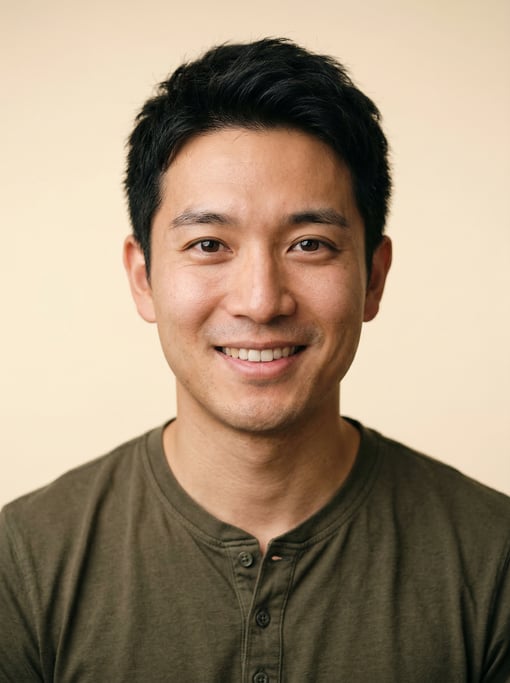 Professional studio headshot of a 29-year-old Japanese man with short textured black hair