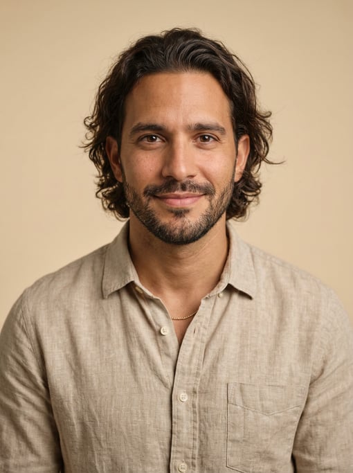 Professional studio headshot of a 35-year-old Dominican man with medium-length wavy dark brown hair